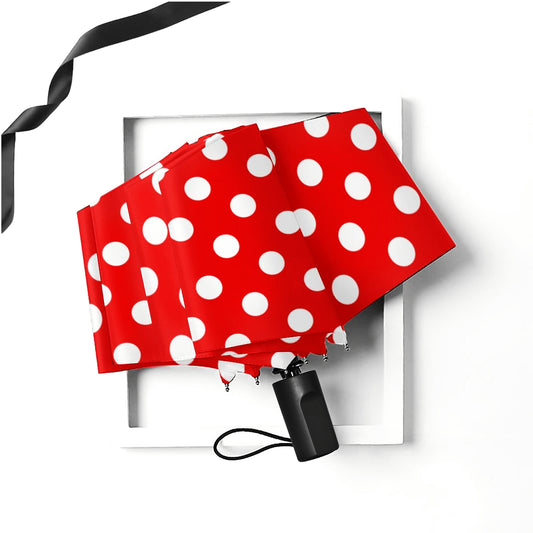 Manueller Taschenschirm mit roten und weißen Punkten
