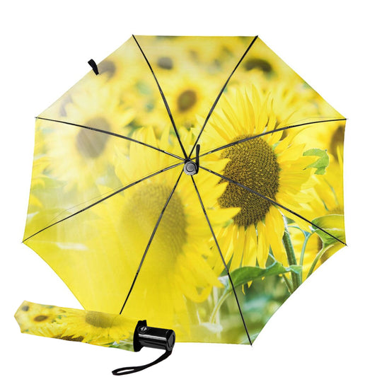 Sonnenblumen-Design im Inneren eines kleinen, kompakten Regenschirms